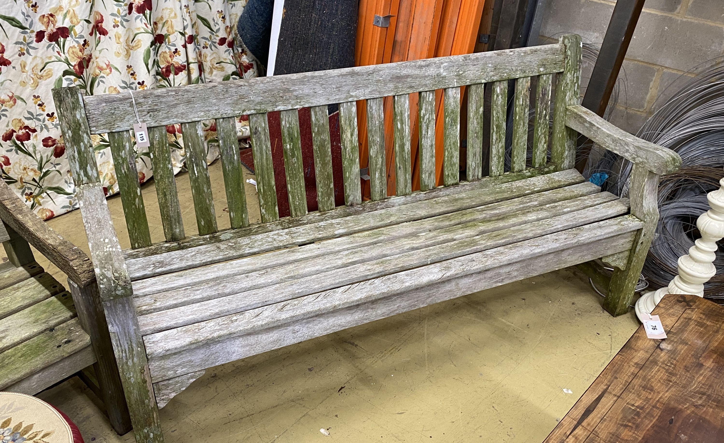 A weathered teak garden bench, length 182cm, depth 52cm, height 90cm